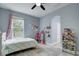 Bright bedroom with tile floor, featuring a window with blinds and view of the backyard at 3603 Arbor Chase Dr, Palm Harbor, FL 34683