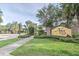 Arbor Chase entrance with brick columns, manicured landscaping, and a gated entrance to the community at 3603 Arbor Chase Dr, Palm Harbor, FL 34683