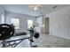 Spacious exercise room with ceiling fan, weight bench, treadmill, stationary bike, and a convenient wet bar setup at 3603 Arbor Chase Dr, Palm Harbor, FL 34683