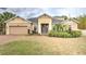 Charming single Gathering home featuring a neutral paint scheme, well-manicured lawn, and mature landscaping at 3603 Arbor Chase Dr, Palm Harbor, FL 34683