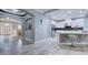 Hallway showcasing tile flooring, arched doorways, neutral paint, and a partial view of the kitchen at 3603 Arbor Chase Dr, Palm Harbor, FL 34683