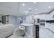 Bright, open kitchen with a breakfast bar, modern appliances, and seamless flow to the living area at 3603 Arbor Chase Dr, Palm Harbor, FL 34683