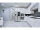 Well-equipped kitchen featuring stainless steel appliances, sleek cabinetry, and stylish backsplash at 3603 Arbor Chase Dr, Palm Harbor, FL 34683