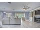 Large living room featuring a fireplace, ceiling fan, and access to an outdoor patio at 3603 Arbor Chase Dr, Palm Harbor, FL 34683