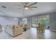 Bright living room with furniture and a sliding glass door to the patio at 3603 Arbor Chase Dr, Palm Harbor, FL 34683