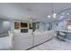 Spacious living room with a fireplace and view to a kitchen island at 3603 Arbor Chase Dr, Palm Harbor, FL 34683