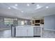 Open floor plan reveals kitchen island with view to the living room and fireplace at 3603 Arbor Chase Dr, Palm Harbor, FL 34683