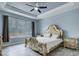Bright bedroom with a large window, stylish bed frame, and tiled floors at 3603 Arbor Chase Dr, Palm Harbor, FL 34683