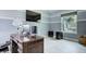 Bright office space with a large window, tile floors, and work desk at 3603 Arbor Chase Dr, Palm Harbor, FL 34683
