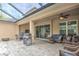 Large covered patio featuring comfortable seating, a grill, and a view of the backyard at 3603 Arbor Chase Dr, Palm Harbor, FL 34683