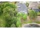 Aerial view of backyard featuring a screened-in pool and peaceful pond views at 3603 Arbor Chase Dr, Palm Harbor, FL 34683
