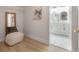 Hallway with a view to bathroom with dual vanities, marble floors, and modern mirrors at 3811 N Arlington Ave, Tampa, FL 33603
