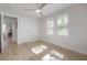 Bedroom with natural light from multiple windows, wood floors, and a ceiling fan creating an inviting atmosphere at 3811 N Arlington Ave, Tampa, FL 33603