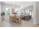 Open concept featuring dining room and kitchen area with modern lighting, seating and large windows at 3811 N Arlington Ave, Tampa, FL 33603