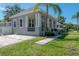 Charming home with a welcoming front porch, beautiful landscaping, and a paved driveway at 3811 N Arlington Ave, Tampa, FL 33603