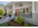Inviting front porch with classic columns, ceiling fans, and decorative railing details at 3811 N Arlington Ave, Tampa, FL 33603