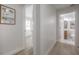 Hallway with a bathroom view that features neutral paint and light wood floors at 3811 N Arlington Ave, Tampa, FL 33603