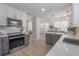 Open kitchen with stainless appliances, white counters, and a view into the dining area at 3811 N Arlington Ave, Tampa, FL 33603