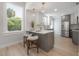 Eat in kitchen with white countertops, gray lower cabinets, and stainless steel appliances at 3811 N Arlington Ave, Tampa, FL 33603