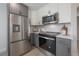 Kitchen showcasing stainless steel appliances and two-tone cabinetry at 3811 N Arlington Ave, Tampa, FL 33603