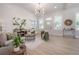 Open-concept living room boasting high ceilings, light-colored flooring, and windows that provide ample natural light at 3811 N Arlington Ave, Tampa, FL 33603