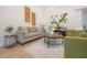Tastefully decorated living room with modern furniture, stylish decor, light wood floors, and plenty of natural light at 3811 N Arlington Ave, Tampa, FL 33603