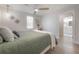 Main bedroom with ceiling fan that looks to a main bathroom suite at 3811 N Arlington Ave, Tampa, FL 33603