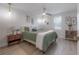 Cozy main bedroom features a ceiling fan and light paint with bright light at 3811 N Arlington Ave, Tampa, FL 33603