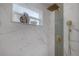 Marble tiled shower with rainfall showerhead and a niche for storage, offering a relaxing spa-like experience at 3811 N Arlington Ave, Tampa, FL 33603