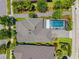 An aerial view of a home with a screened-in pool and well-maintained backyard at 3833 Villamore Ln, Odessa, FL 33556