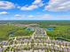 Aerial view of a scenic Primary-planned community with lush green trees and tranquil lakes at 3833 Villamore Ln, Odessa, FL 33556