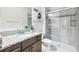 Bathroom featuring granite countertops, a shower, and vanity at 3833 Villamore Ln, Odessa, FL 33556