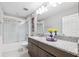 Bathroom featuring granite counters, a glass enclosed tub-shower and decorative decor at 3833 Villamore Ln, Odessa, FL 33556