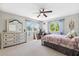 Bright bedroom featuring a computer desk, with views of lush trees outside the windows at 3833 Villamore Ln, Odessa, FL 33556