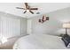 A brightly lit bedroom featuring a cozy double bed and neutral walls at 3833 Villamore Ln, Odessa, FL 33556