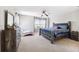 Bedroom featuring a large bed, dresser, and comfortable seating area at 3833 Villamore Ln, Odessa, FL 33556