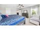 Comfortable bedroom with a large bed, dresser, and a view of the outdoors at 3833 Villamore Ln, Odessa, FL 33556