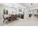Bright dining room with modern light fixture, tile floors, and view into the living area at 3833 Villamore Ln, Odessa, FL 33556