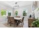 A spacious dining room is filled with natural light, adjacent to the living area at 3833 Villamore Ln, Odessa, FL 33556