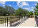 Fenced dog park featuring a bench, waste station, and ample space for pets to roam and play within the community at 3833 Villamore Ln, Odessa, FL 33556