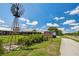 Scenic exterior view of a market building with a windmill and a sign advertising fresh produce and live music at 3833 Villamore Ln, Odessa, FL 33556