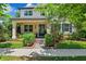 Charming home featuring a covered front porch, lush landscaping, and a welcoming entrance at 3833 Villamore Ln, Odessa, FL 33556