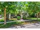 Charming home featuring a welcoming front porch, beautiful landscaping, and vibrant green lawn at 3833 Villamore Ln, Odessa, FL 33556