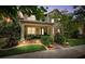 Inviting home with a charming front porch, lush landscaping, and appealing curb appeal at twilight at 3833 Villamore Ln, Odessa, FL 33556