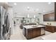 Open kitchen features stainless appliances, granite counters and a large island perfect for dining at 3833 Villamore Ln, Odessa, FL 33556