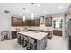 Modern kitchen featuring a large center island with seating and stainless steel appliances at 3833 Villamore Ln, Odessa, FL 33556