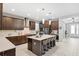 Modern kitchen with stainless appliances, granite counters, a gas cooktop, island, and barstool seating at 3833 Villamore Ln, Odessa, FL 33556