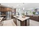 Open kitchen featuring stainless appliances, granite counters and a large island for entertaining guests at 3833 Villamore Ln, Odessa, FL 33556