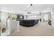 Spacious living room with plush carpeting, large sectional sofa, and modern entertainment center at 3833 Villamore Ln, Odessa, FL 33556
