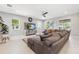 Bright living room with comfortable seating, area rug, and large windows offering ample natural light at 3833 Villamore Ln, Odessa, FL 33556